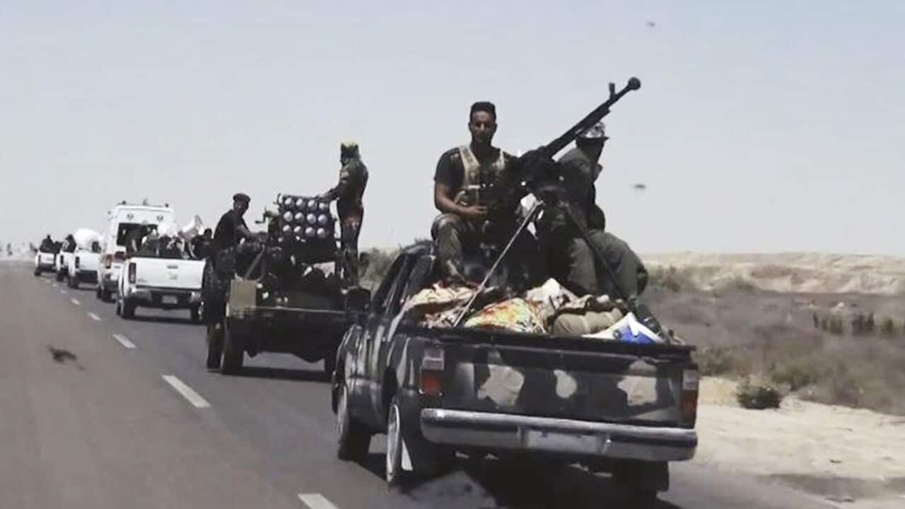 This file photo shows Iraqi security forces backed by Shiite and Sunni pro-government fighters preparing to attack Islamic State group positions in Fallujah