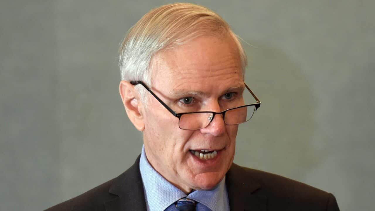 Philip Alston talks at a press briefing.