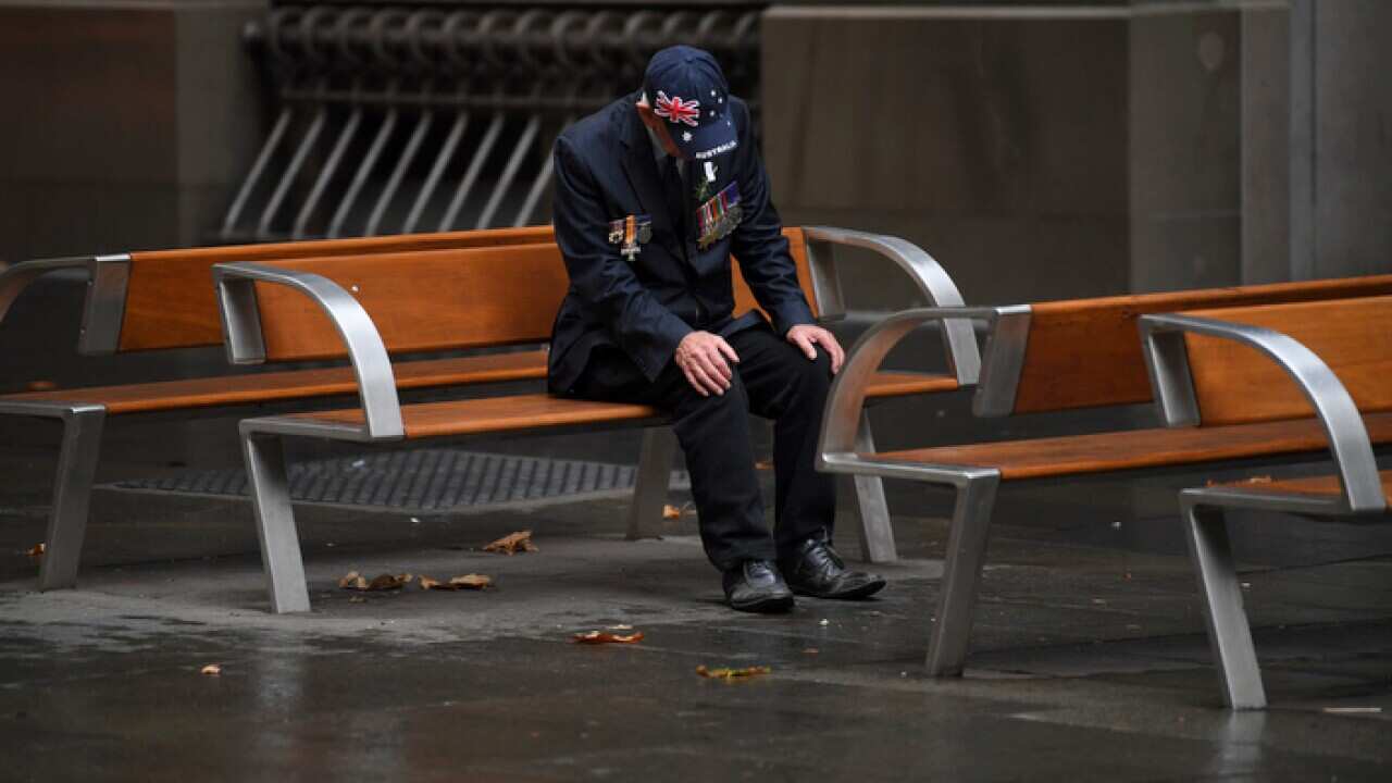 An elderly man sits after attending an Anzac Day Dawn Service in Sydney (AAP)