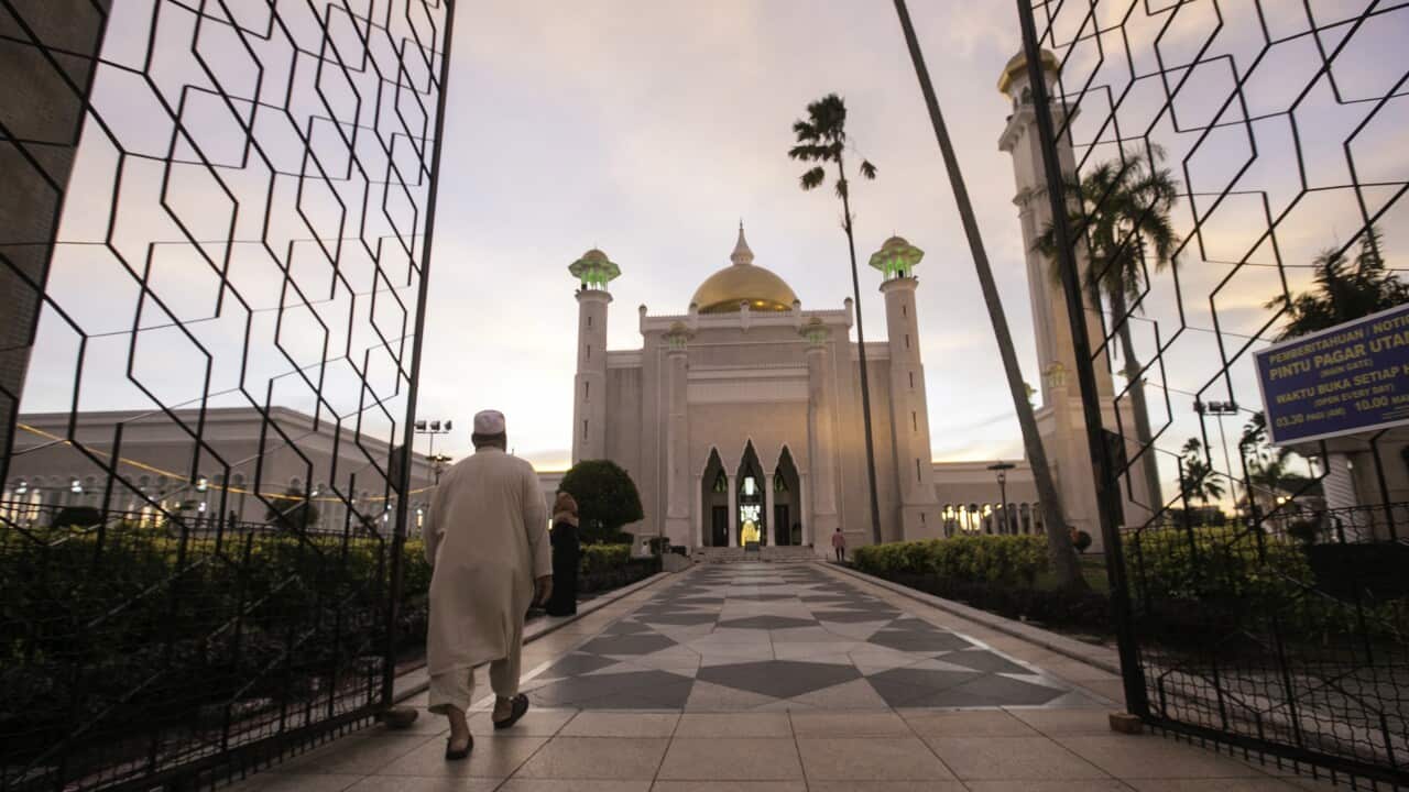 A Muslim man walks inside the Sultan Omar Ali Saifuddien mosque to perform the sunset prayer in Bandar Seri Begawan, Brunei.