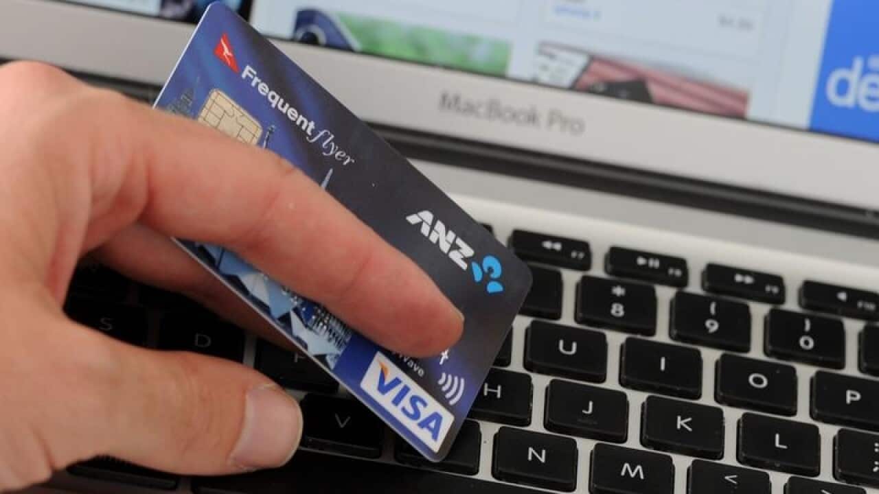 A credit card in front of an online shopping site
