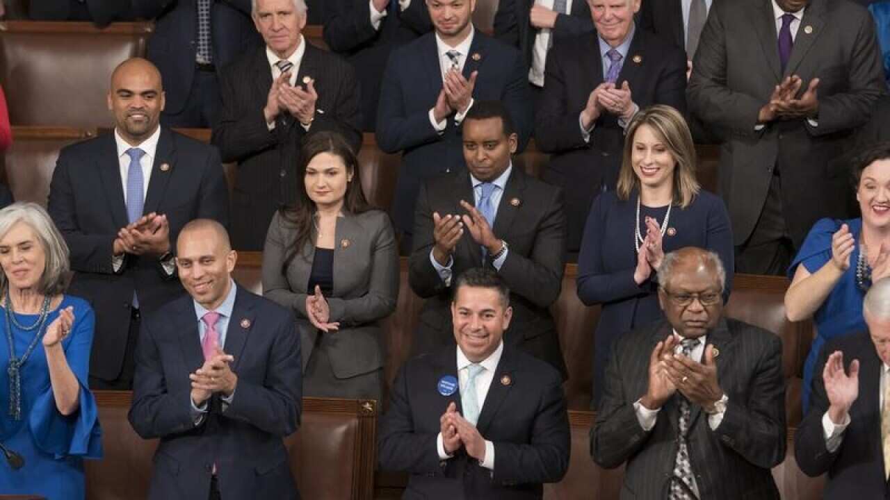 Members of the new House Democratic leadership applauding