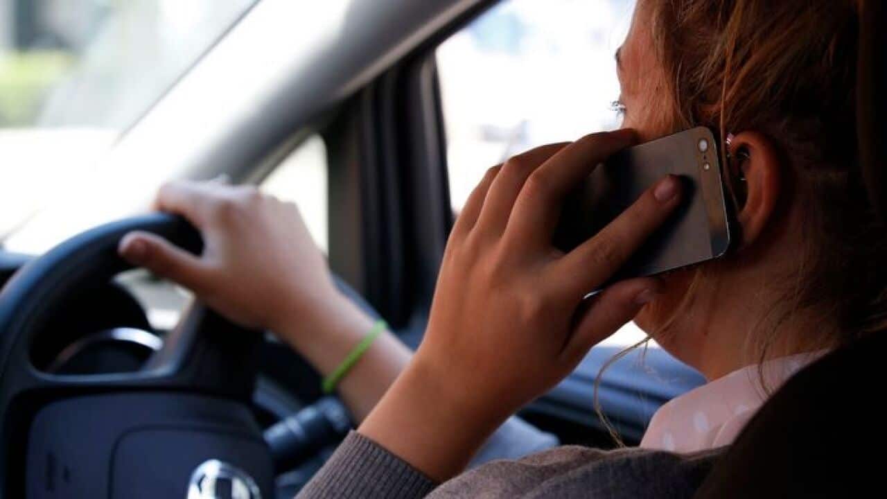 Woman talking on her phone while driving