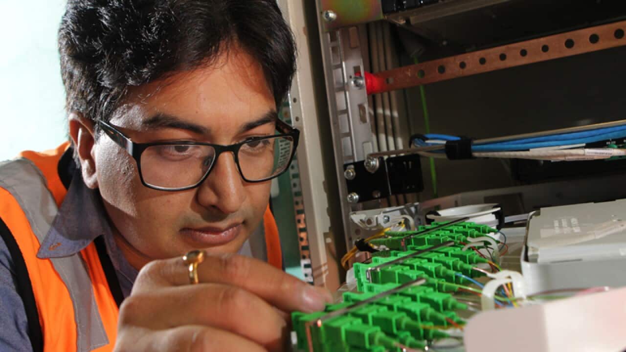 An NBN technician connects an apartment block