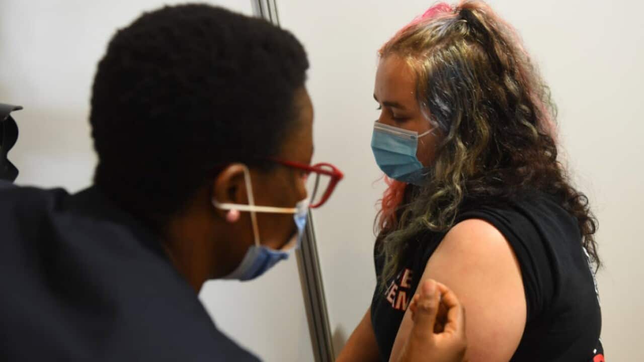A woman receives an AstraZeneca vaccination at the Royal Exhibition Centre in Melbourne, Monday, March 22, 2021