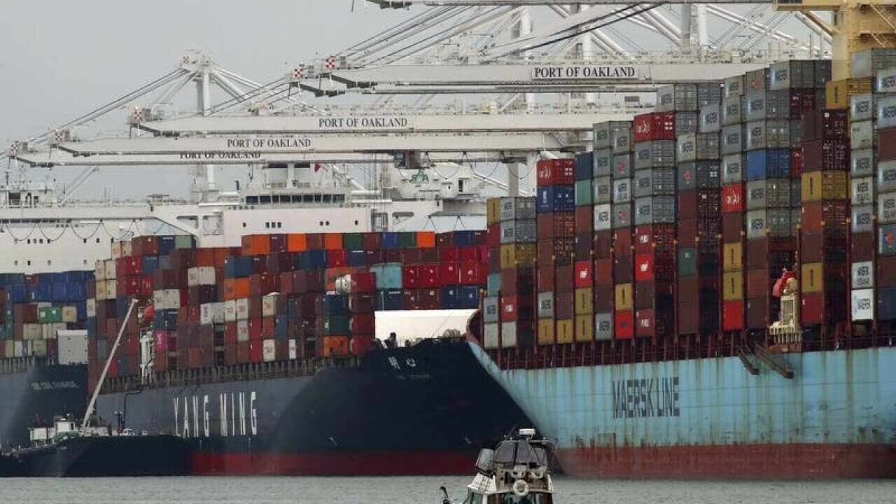 Container ships unload at a California port