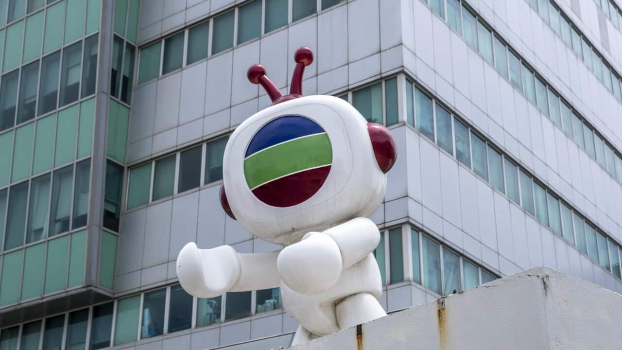 The mascot for Hong Kong broadcaster TVB on top of a building