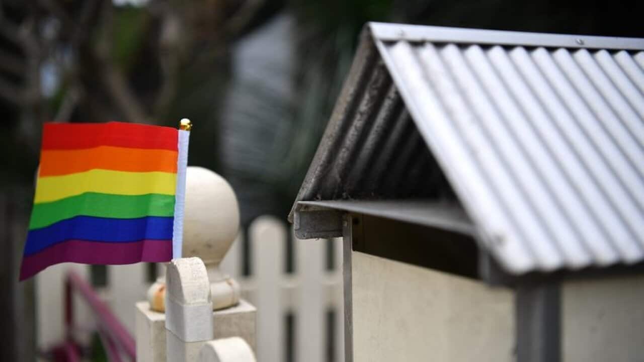 A rainbow flag in support of a Yes vote in the marriage equality postal survey is seen on a fence in Sydney's inner west, Tuesday, October 3, 2017. (AAP Image/Joel Carrett) NO ARCHIVING