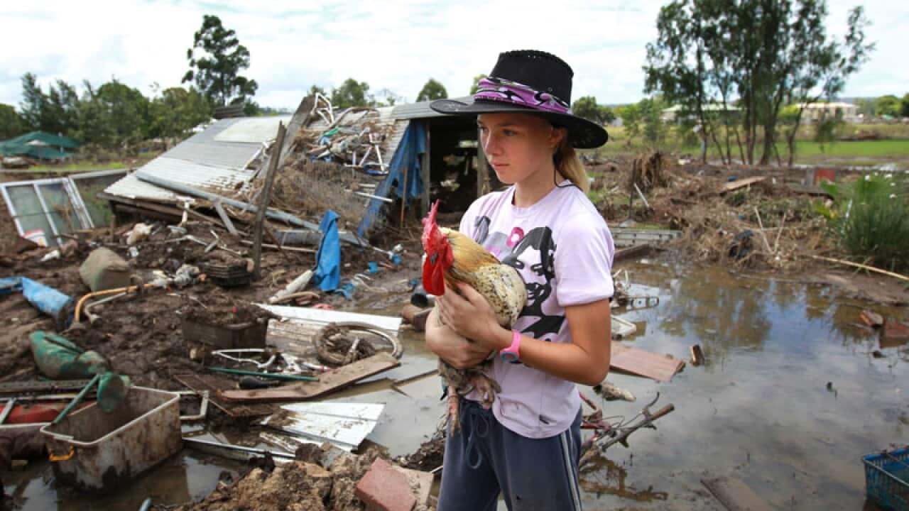 Stuart McEvoy captures 14 year old Katherine Godley in the backyard of her Grantham home after a flood of water devastated the area.