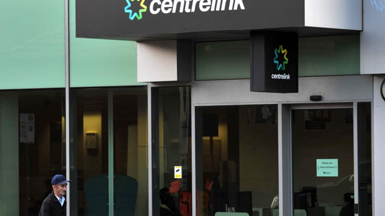 A man walks past a Centrelink branch in Melbourne