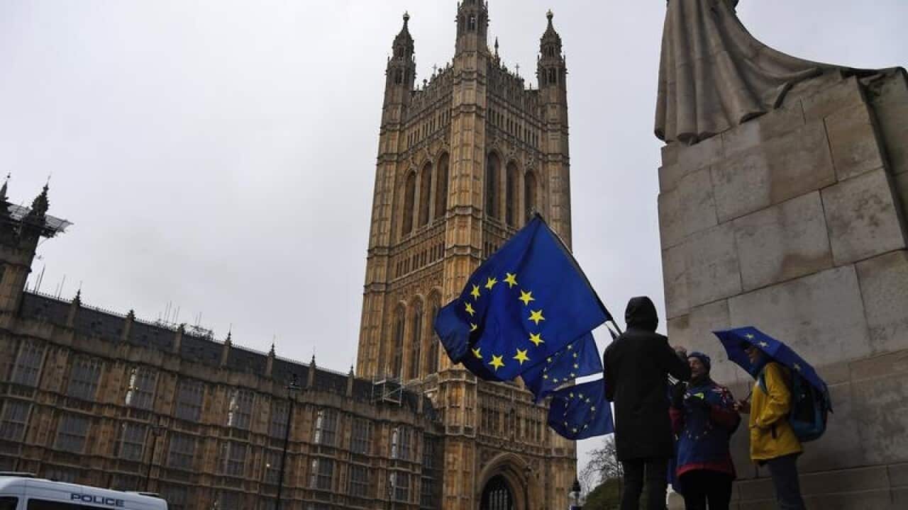 Anti-Brexit protesters gather outside parliament in London.