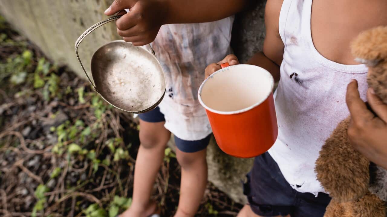 Cropped view of homeless african american kids holding cup and metal plate while begging alms on