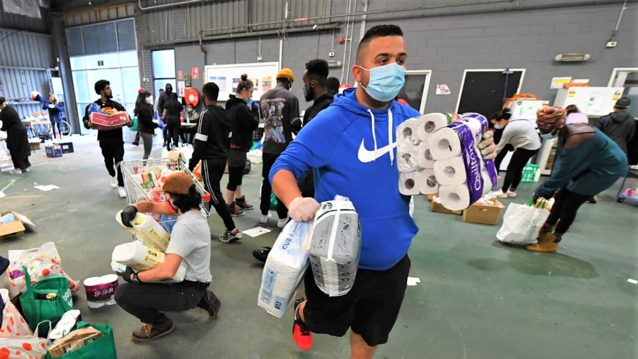 Volunteers scramble to organise food and personal hygiene supplies at the Australian Muslim Social Services Agency in North Melbourne.