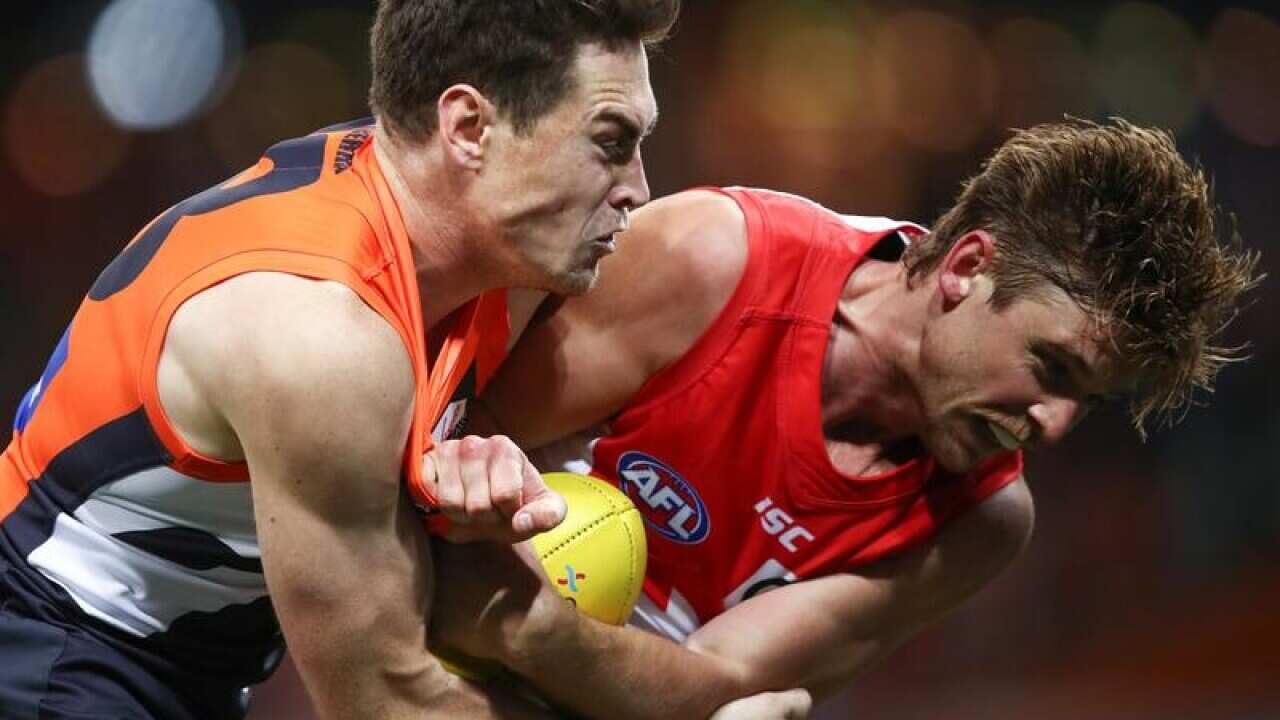 GWS's Jeremy Cameron and Sydney's Dane Rampe (R) contest the ball