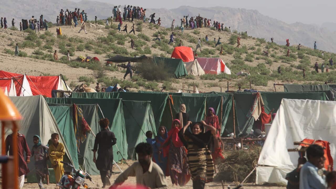 People affected by floods wait for relief in Sehwan, Sindh province, Pakistan on 1 September 2022.