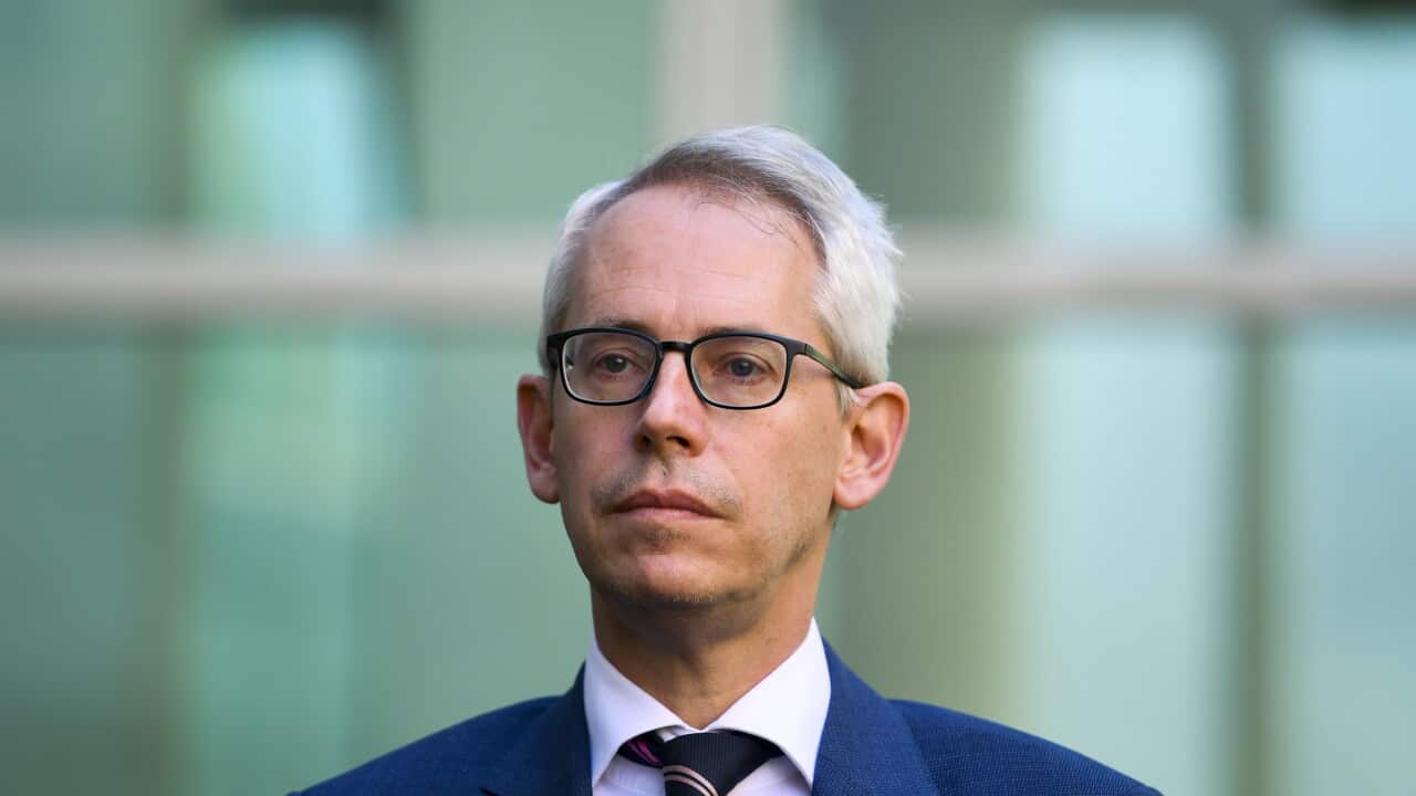 Immigration Minister Andrew Giles at a press conference.