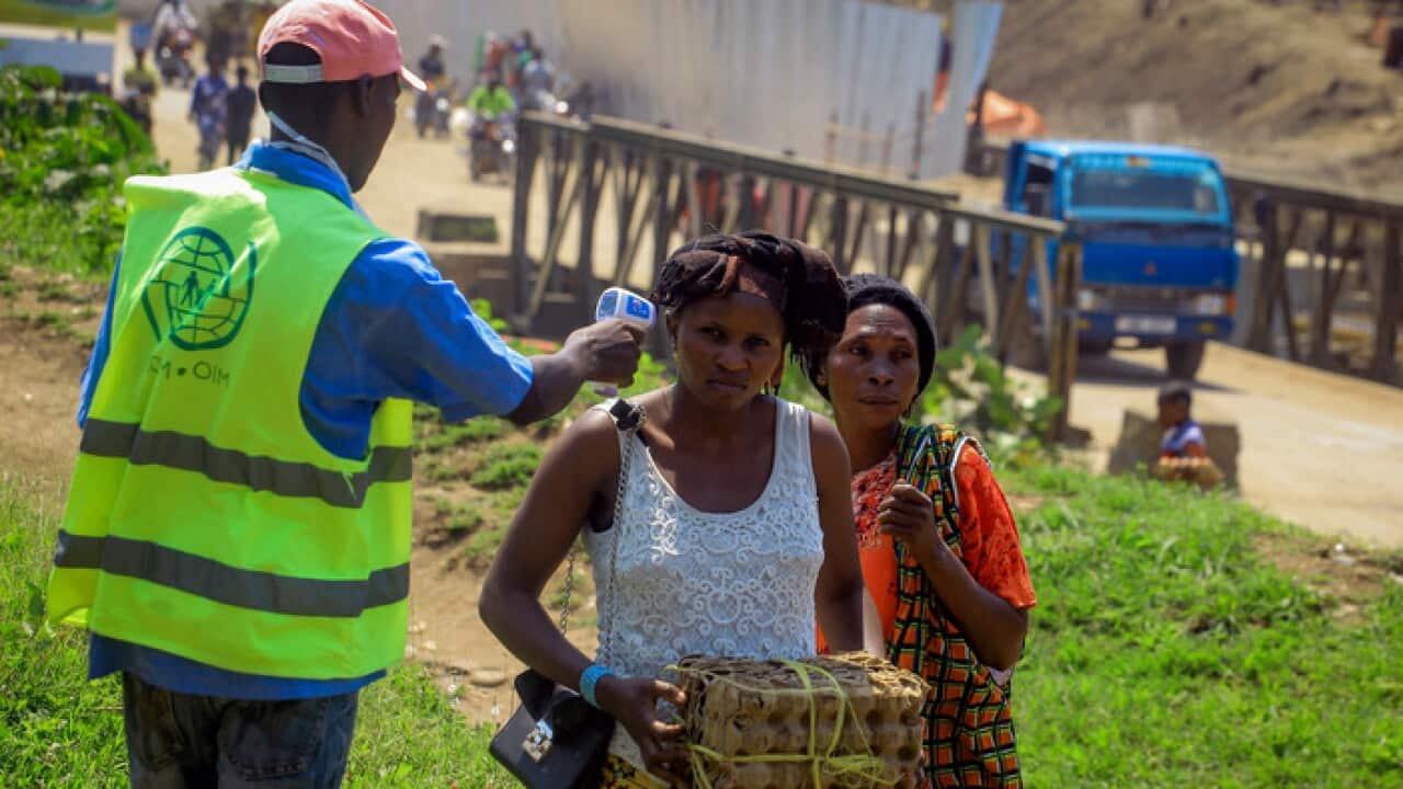 People are being checked for Ebola virus at crossing near Kasindi