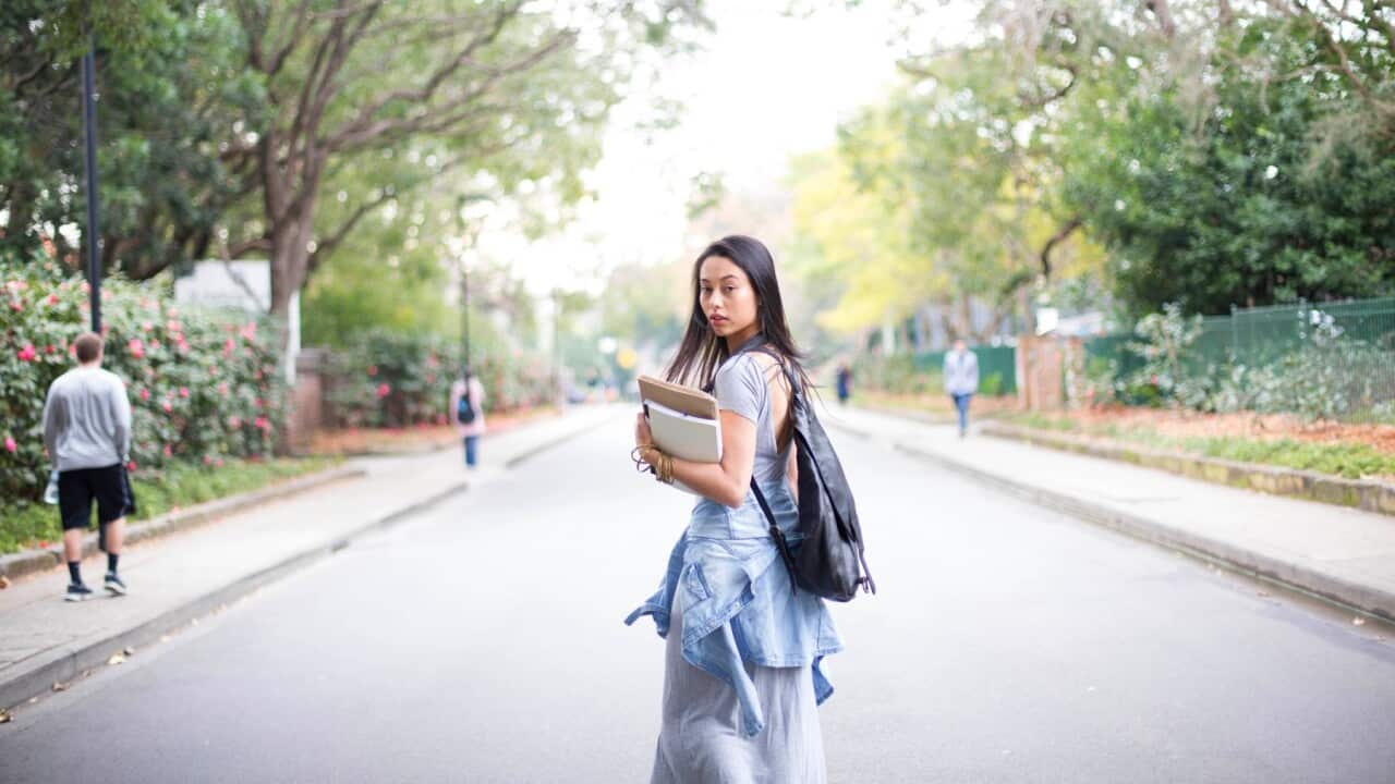 An international student taking a phot on the road - GettyImages