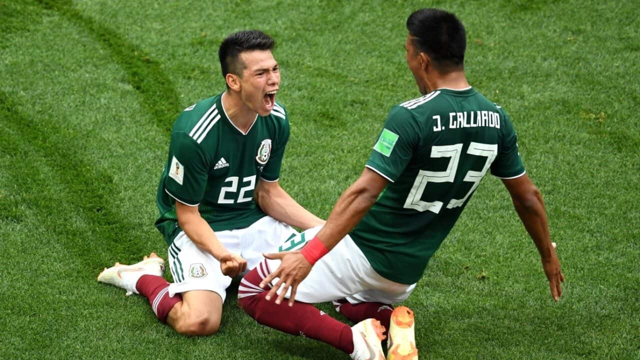 Hirving Lozano of Mexico celebrates with Jesus Gallardo by sliding on their knees after scoring his team's first goal