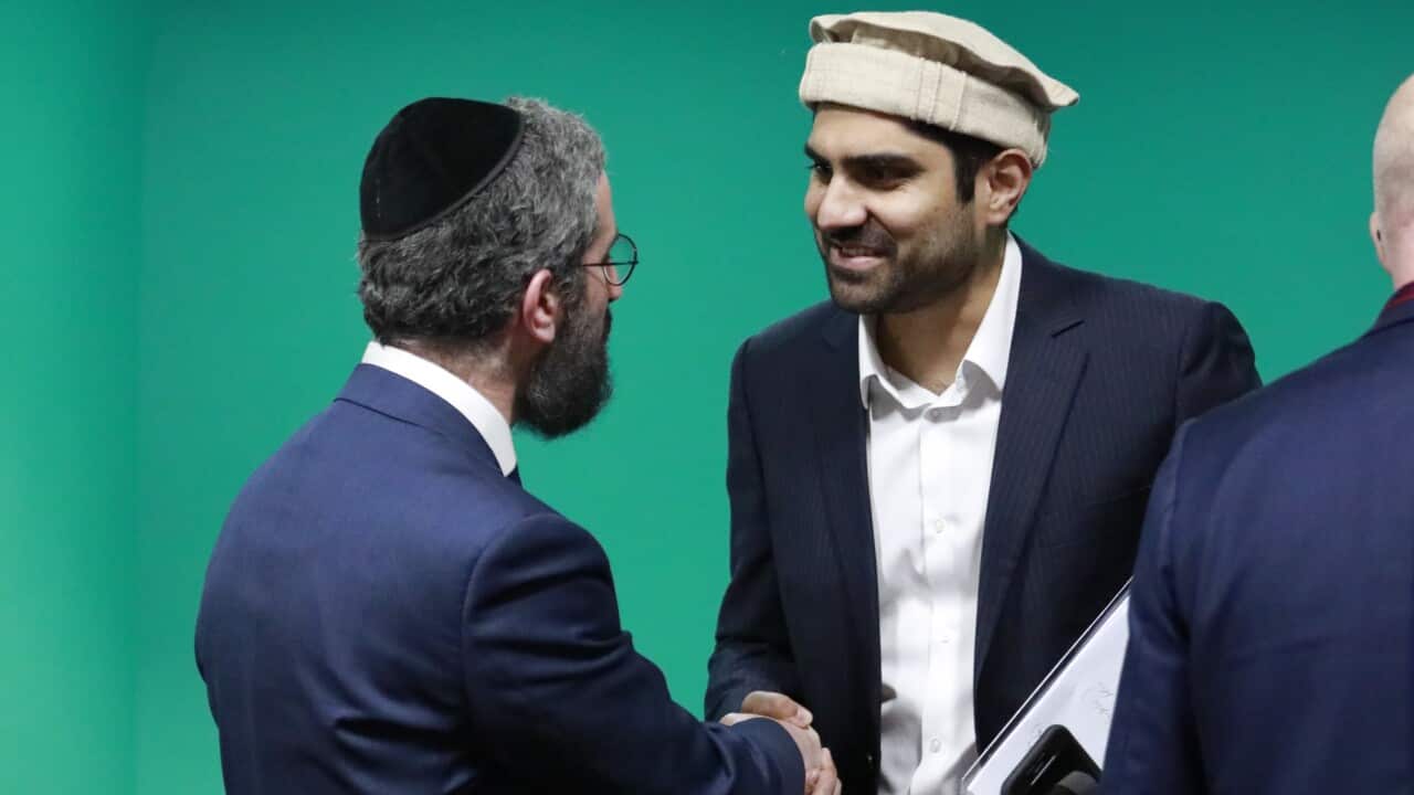 Two men shake hands