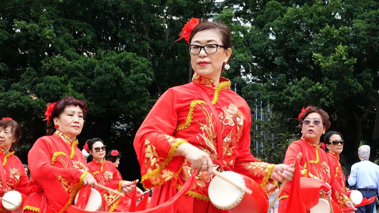 Asian Women at Work drumming group performing in Sydney