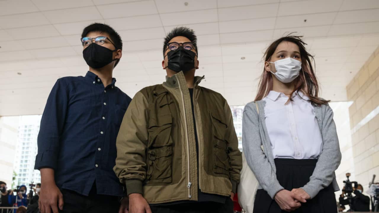 Joshua Wong (L), Ivan Lam (C), and Agnes Chow (R) arrive at the West Kowloon Law Courts building last month