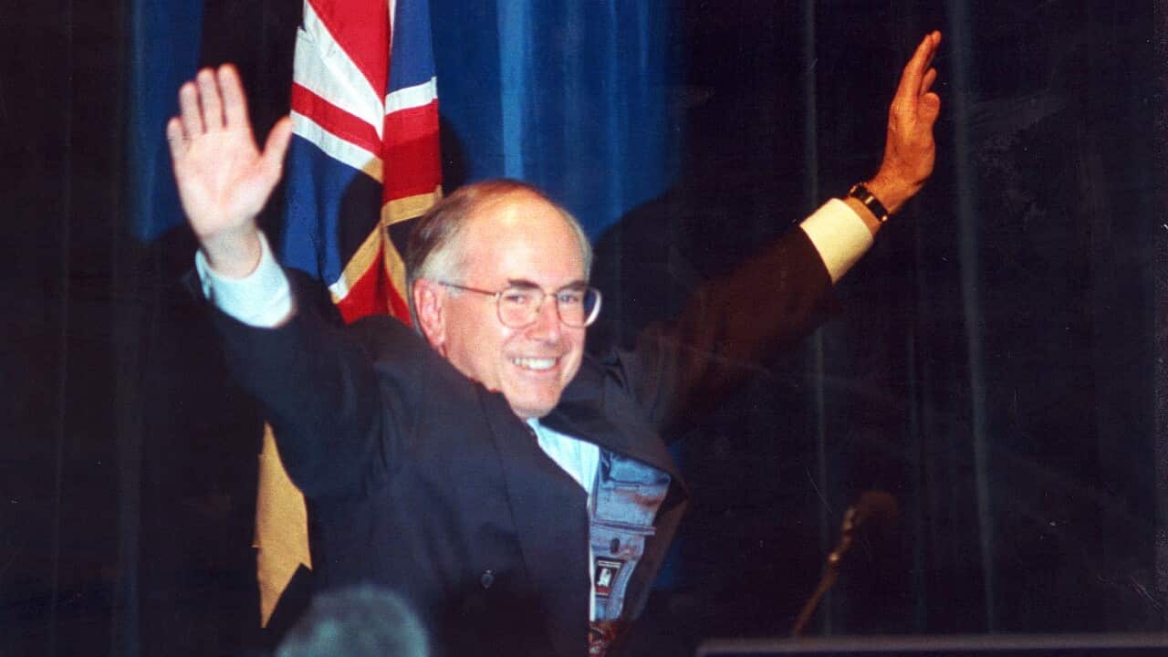 A March 2, 1996 file photo of Liberal party Leader John Howard waves to the crowd in a Sydney Hotel as he acknowledges his federal election victory. (AAP Image)
