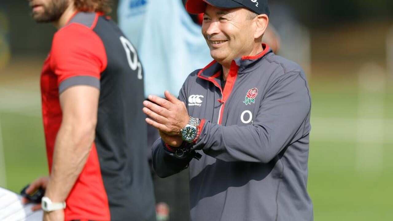 Eddie Jones claps the England players during a training session.