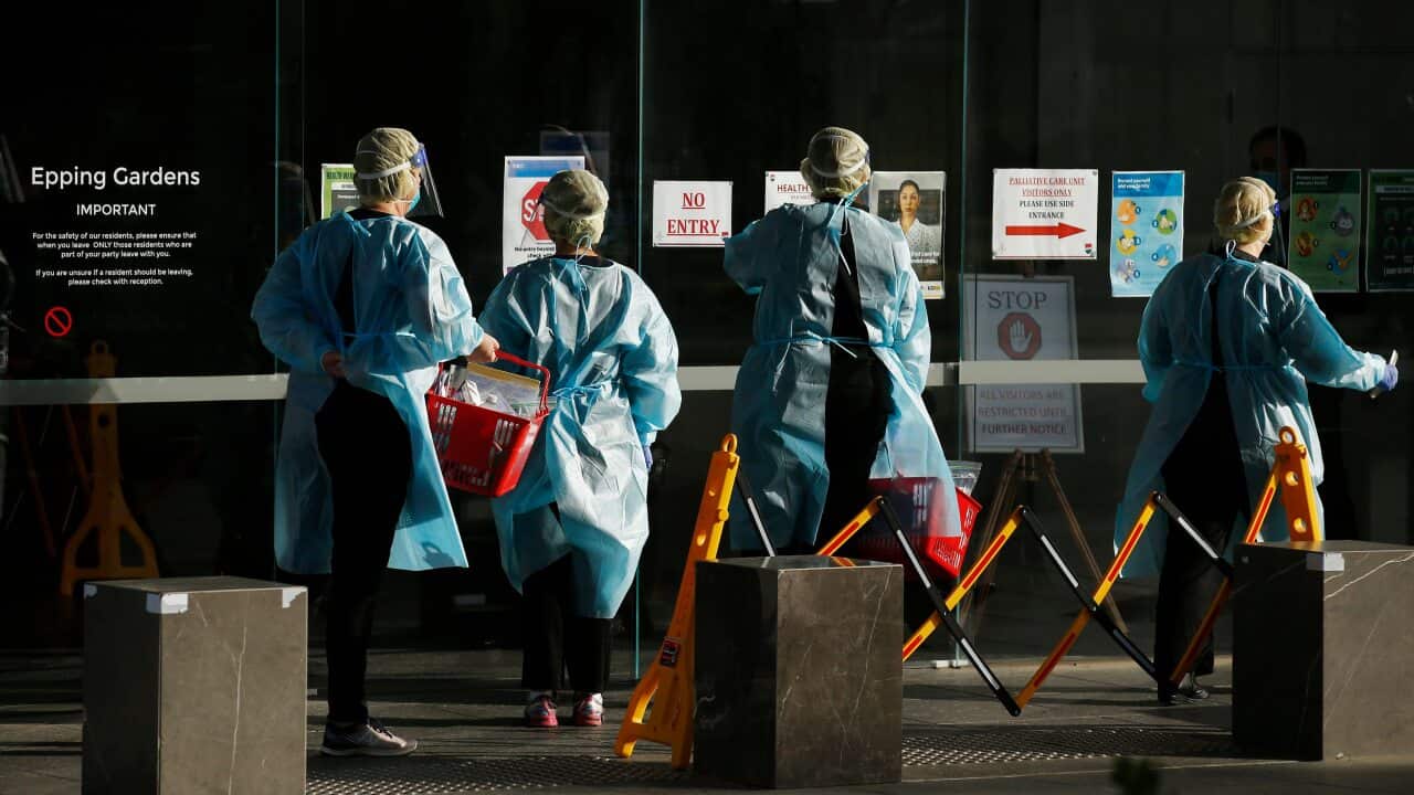 Cleaners are seen at Epping Gardens aged care facility in Epping, Melbourne, where a further 169 cases have been confirmed.