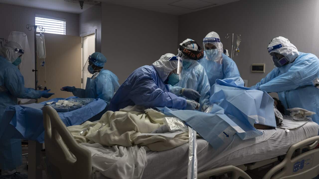 Medical staff members treat a patient suffering from coronavirus in the COVID-19 intensive care unit at the United Memorial Medical Center in Houston, Texas.