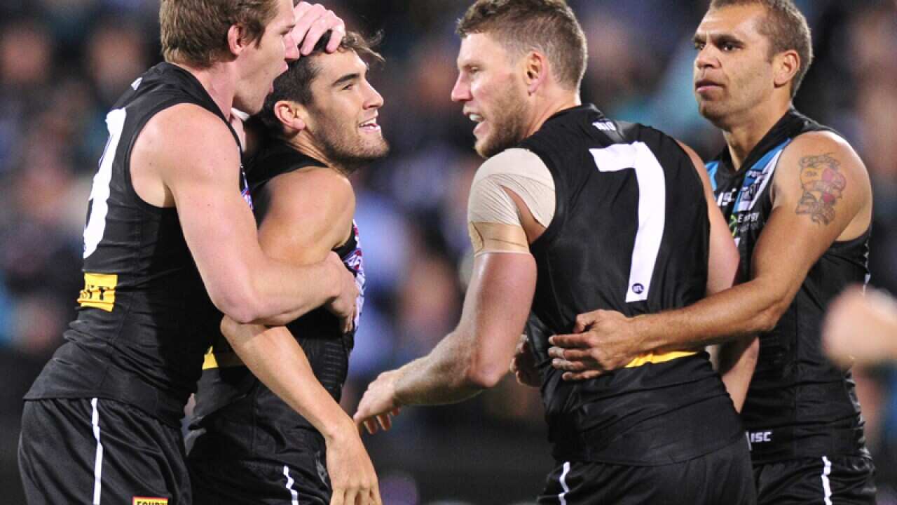 Port Adelaide's Chad Wingard  (2nd from L) celebrates goal