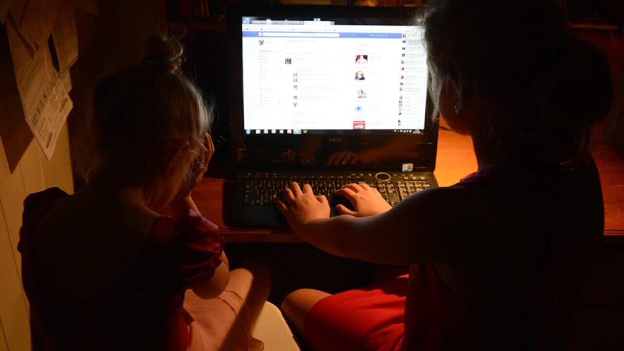 Young girls use a personal computer