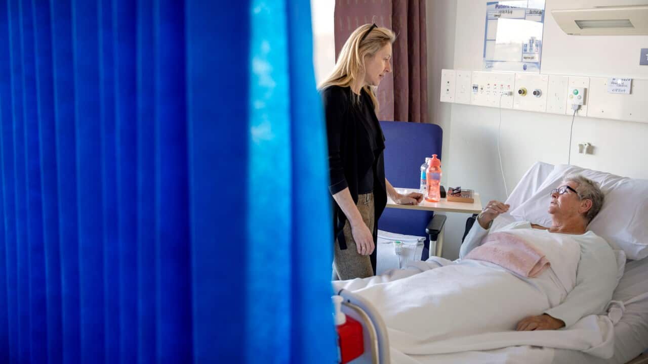 Dr. Jennifer Stevens, a pain specialist, talks with patient Cheryl Rowley who is awaiting surgery at St. Vincent's Hospital in Sydney, July 2019.
