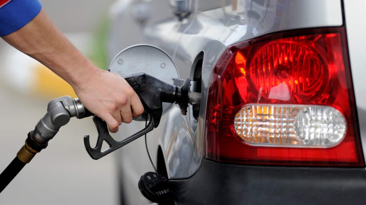 A man pumps petrol at a service station
