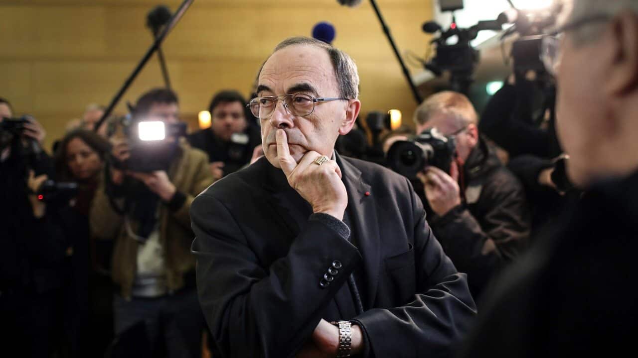 Cardinal Philippe Barbarin waits for the start of his trial at the Lyon courthouse, central France.