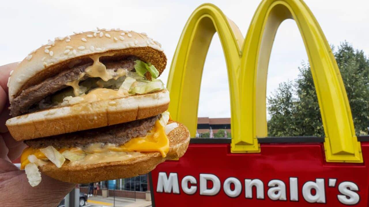 A McDonald's Big Mac, their signature sandwich is held up near the golden arches at a McDonalds's August 10, 2015, in Centreville, Virginia. AFP PHOTO/PAUL J. RICHARDS (Photo credit should read PAUL J. RICHARDS/AFP/Getty Images)
