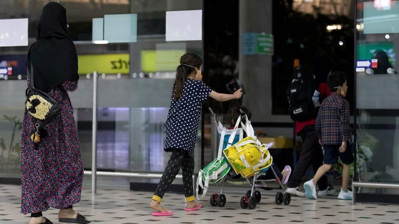 Afghanistan evacuees arrive at an Australian airport terminal.