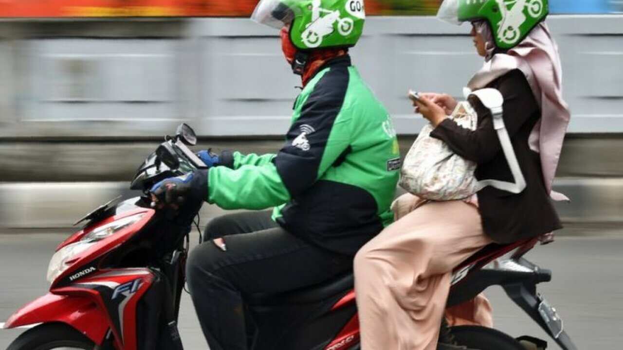 A Gojek driver and his passenger negotiate the challenges of travelling in Jakarta - Feb 2, 2017.