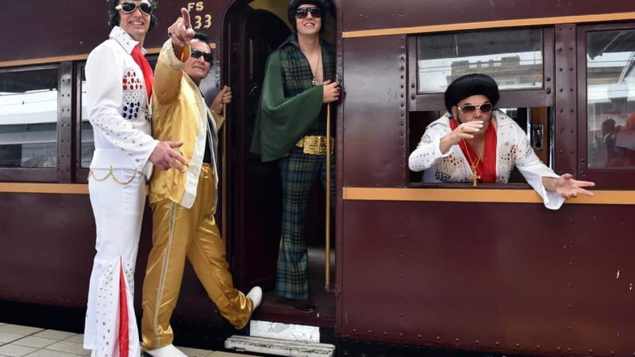 Elvis impersonators board the Blue Suede Express