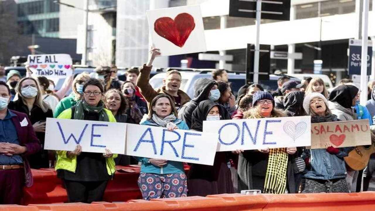 Supporters of the victims react outside the High Court in Christchurch, New Zealand, Thursday, August 27, 2020.