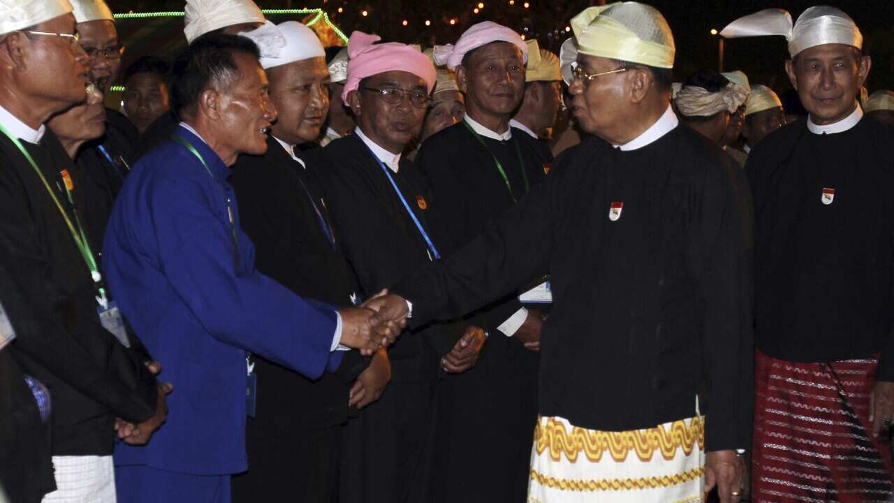 Myanmar's top leader Senior Gen. Than Shwe, right, greets guests during dinner to mark the 64th anniversary of Union Day Saturday, Feb. 12, 2011,