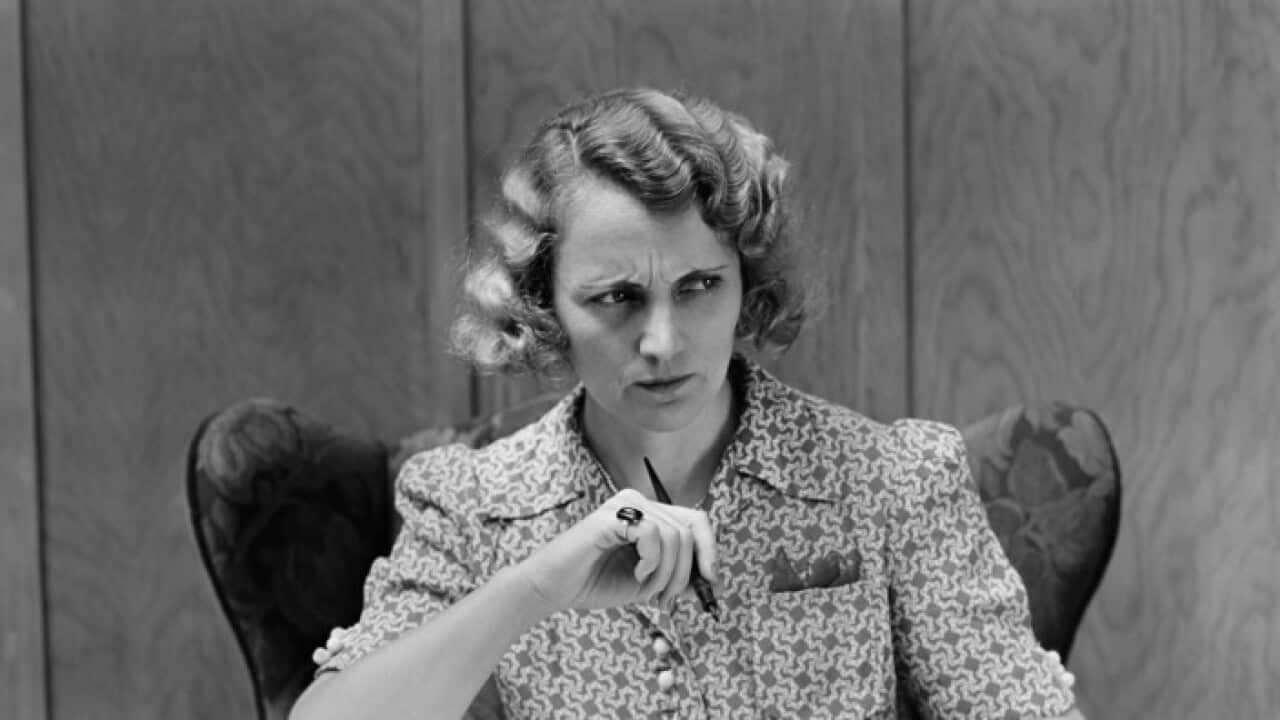 Serious worried woman at desk