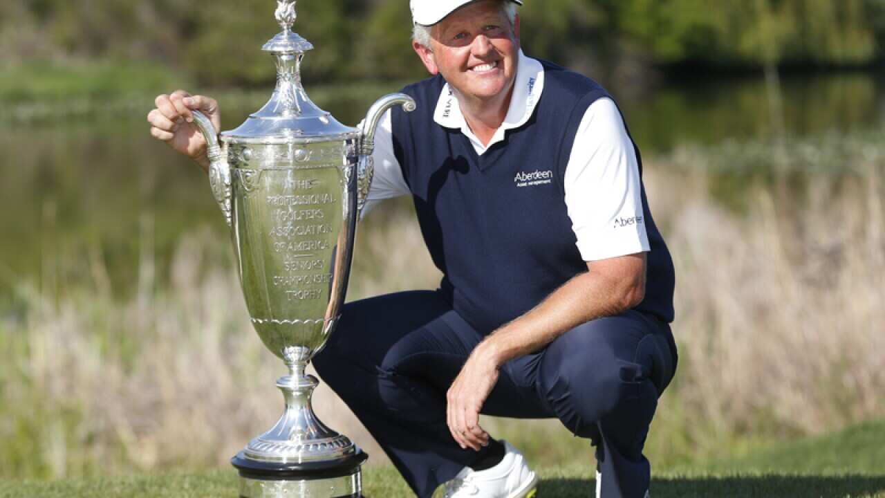 Colin Montgomerie poses with the Alfred S. Bourne trophy.