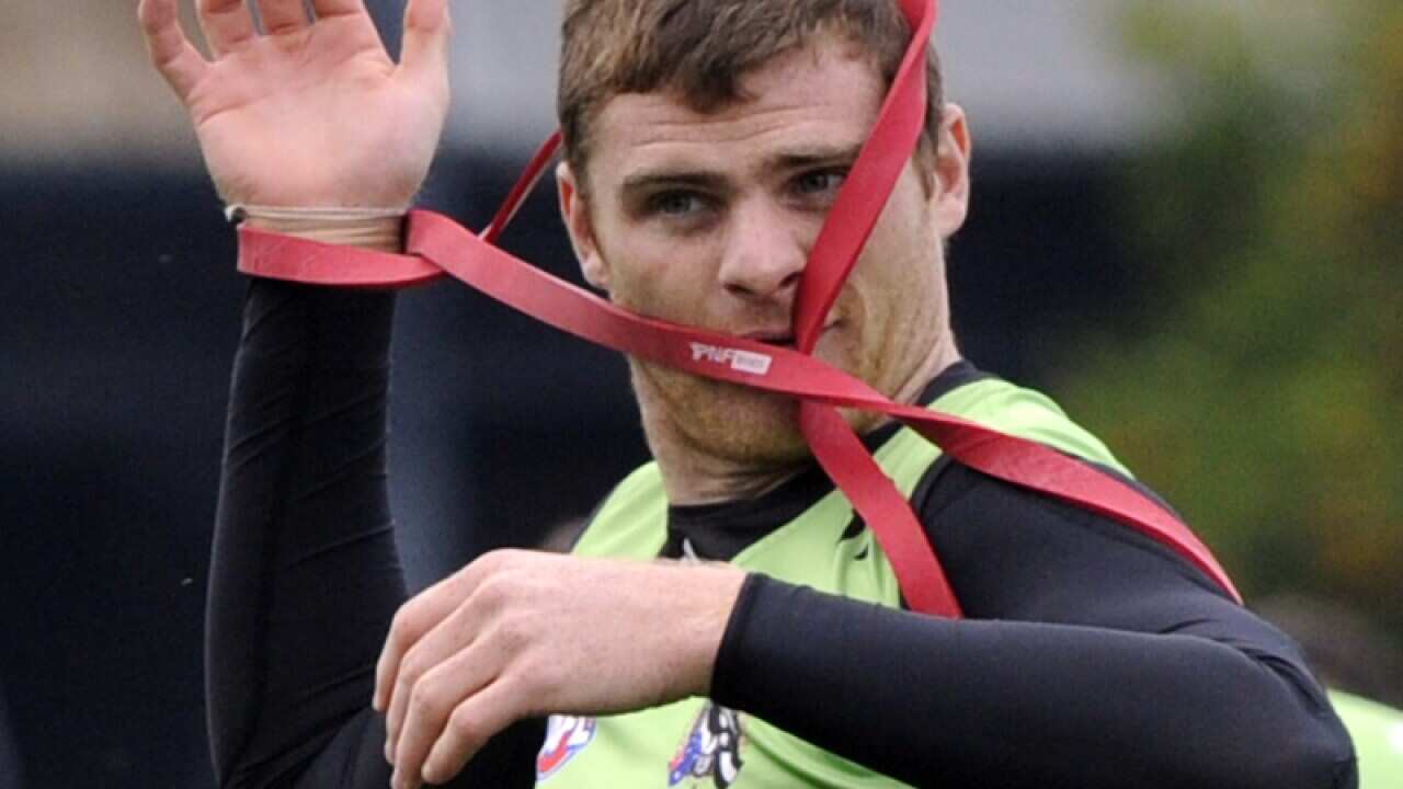 Heath Shaw puts on a training device