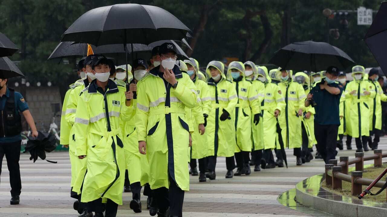 South Korean police officers wearing face masks walk in Seoul, South Korea, Saturday, August 15, 2020
