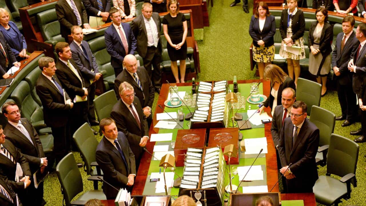 All members of Victoria's legislative assembly stand