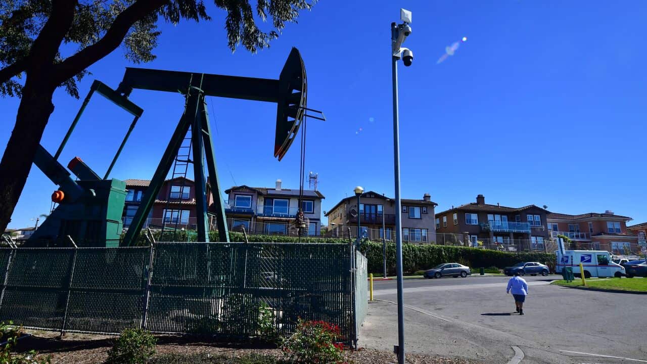 A working oil derrick in front of  homes in Signal Hill, Los Angeles