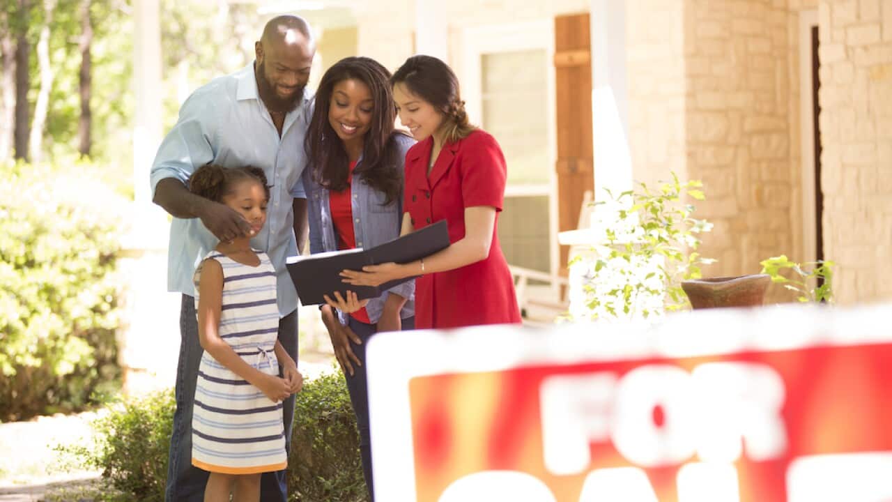 Realtor and family looking at new home to purchase.