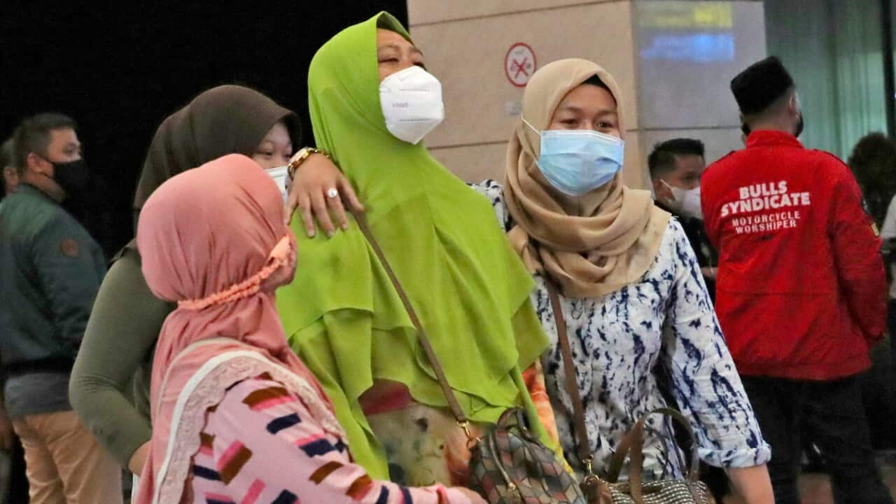 Relatives of passengers arrive at a crisis centre at Soekarno-Hatta International Airport in Tangerang