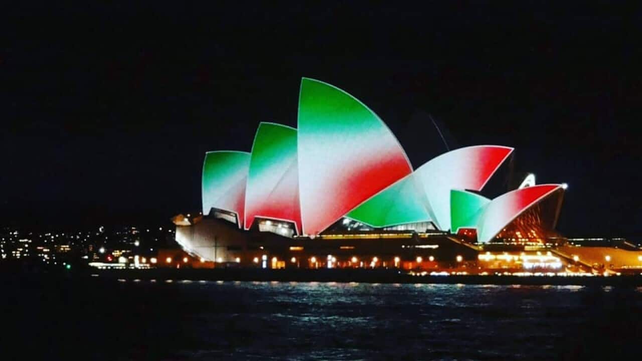 The sails of the Opera House illuminated with the colors of the Italian flag on 2 June 2021